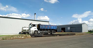 Dumper trucks being weighed as they arrive at the distillery